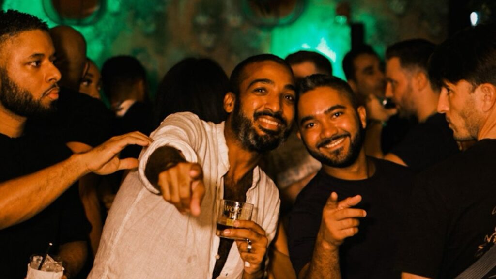 Mystic Thai Jamaica Friday night scene with cocktails, DJ, and dinner guests