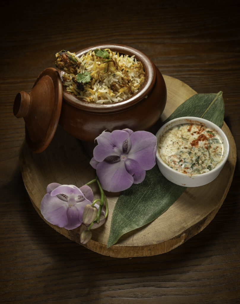 Fragrant Chicken Biryani layered with spiced chicken, basmati rice, and fresh herbs at Mystic Thai Jamaica.
