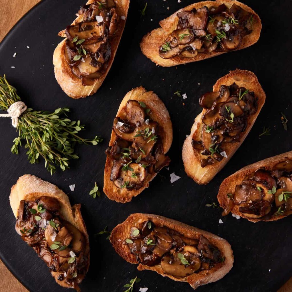 Mushroom bruschetta with sautéed mushrooms on toasted bread at Mezzaluna Jamaica