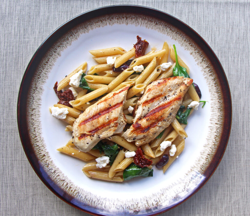 Chicken pasta grilled chicken Mediterranean pasta dish Mezzaluna Jamaica